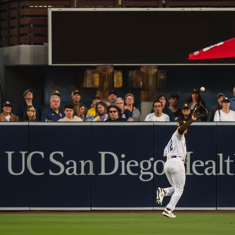 San Diego Padres outfielder reaching to catch ball