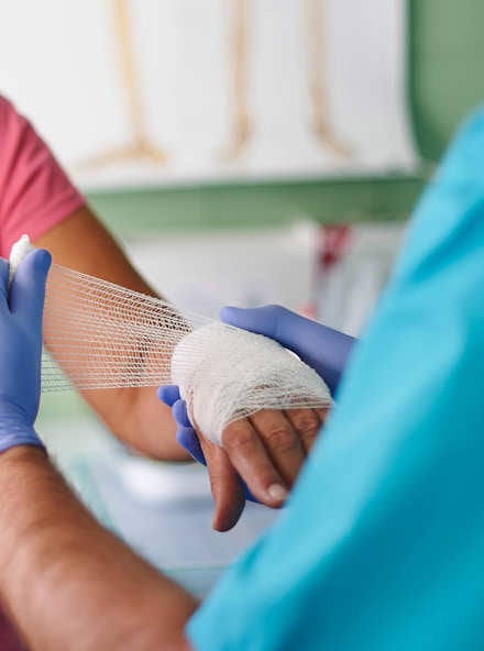 nurse bandages patient's hand