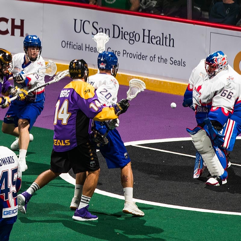 San Diego Seals lacrosse players with UC San Diego Health banner in the background