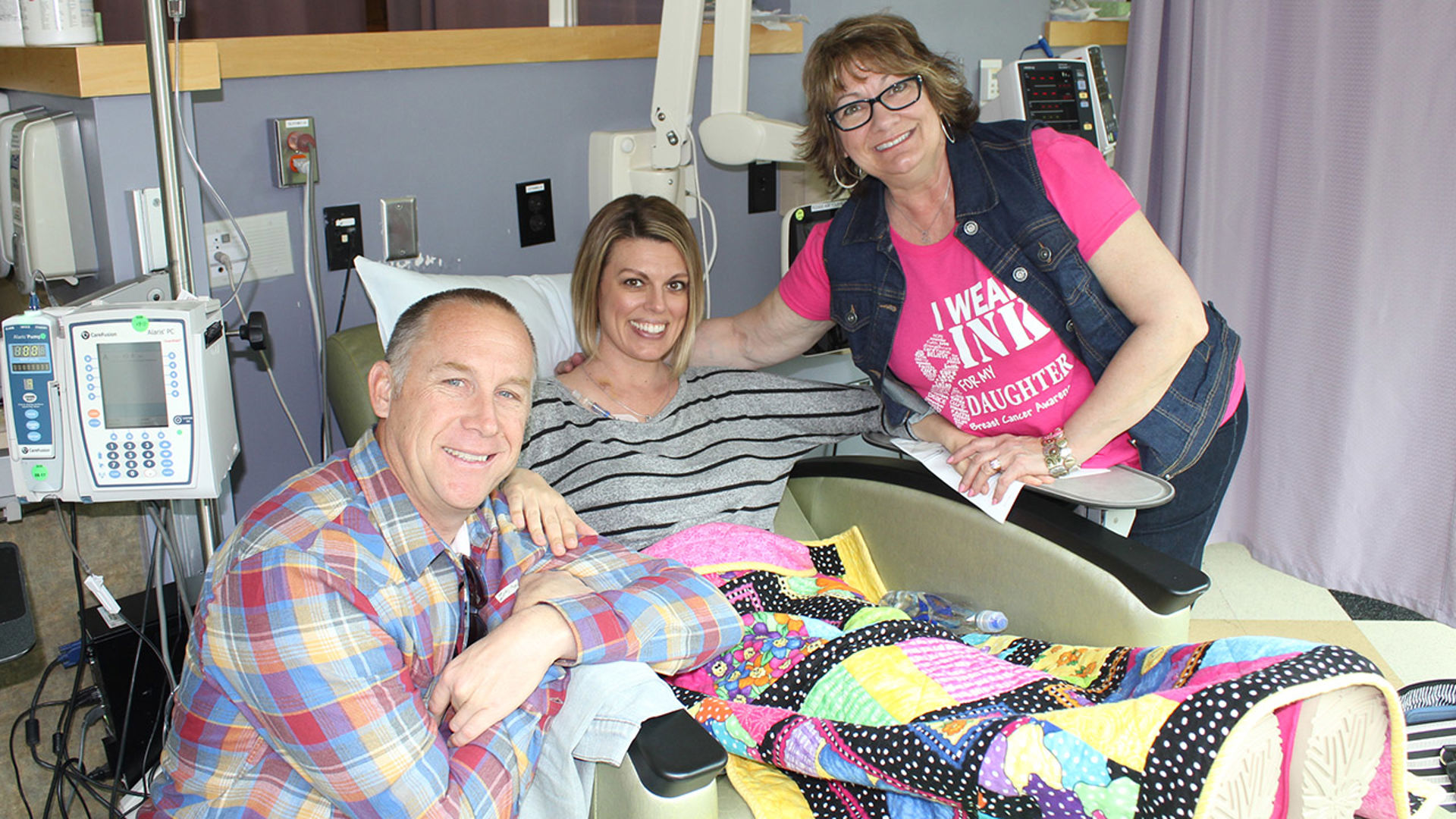 Michelle with husband and mom receiving chemotherapy
