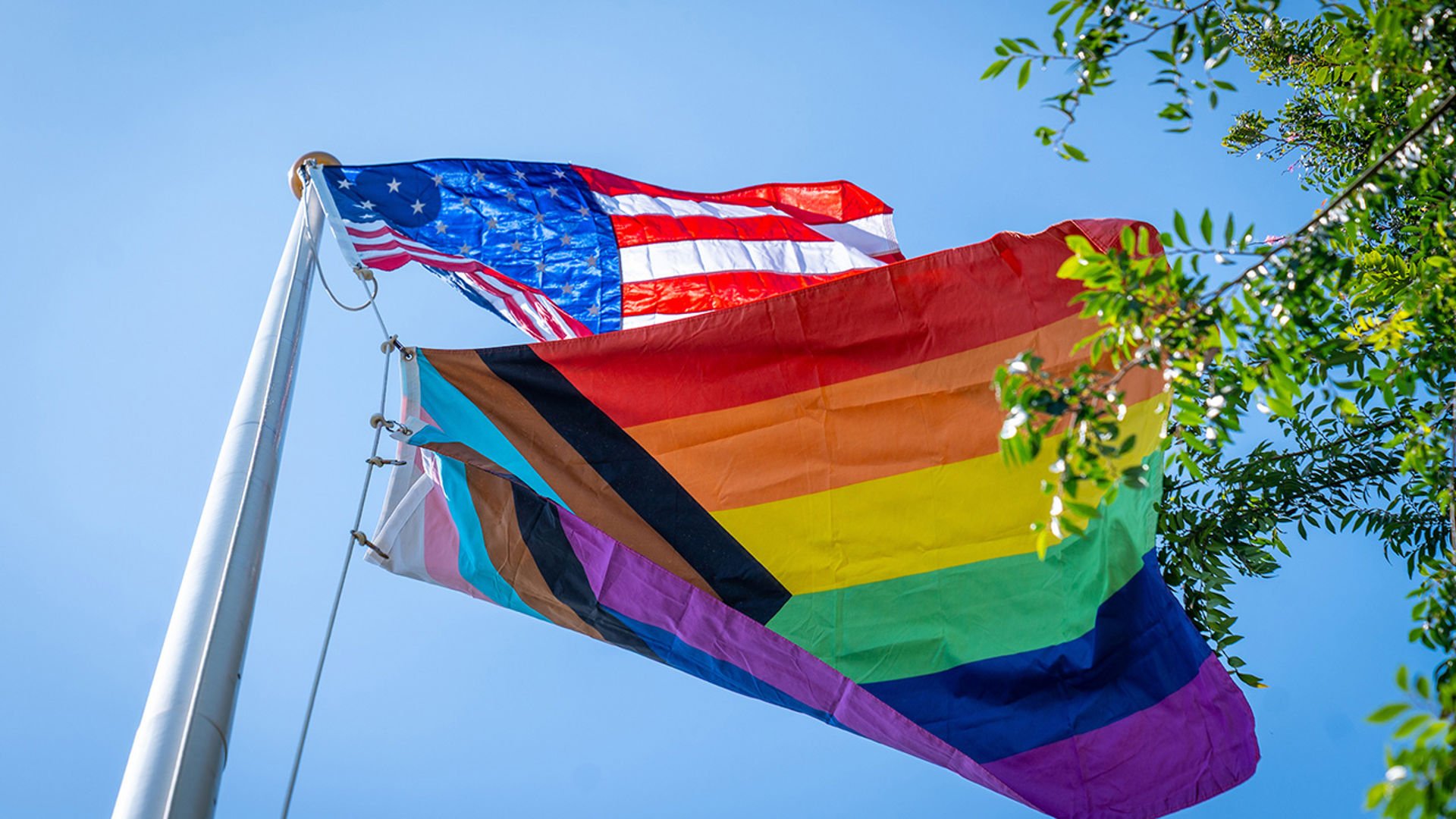 Pride Flag and US flag flying