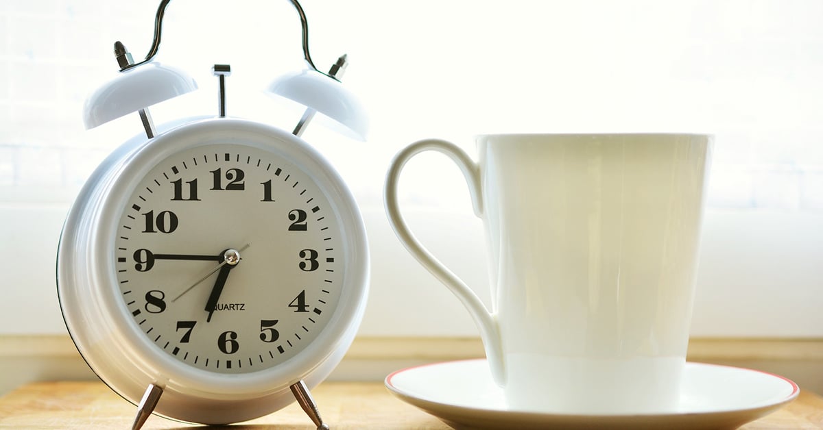 Alarm clock next to coffee mug