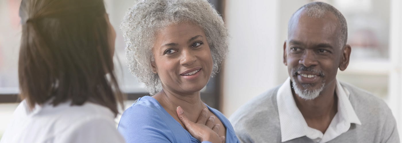Health care provider talks with an older couple