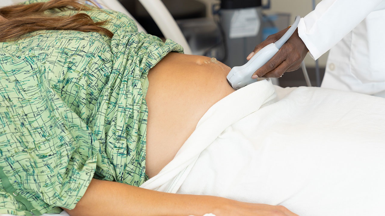 Doctor performing ultrasound with pregnant patient