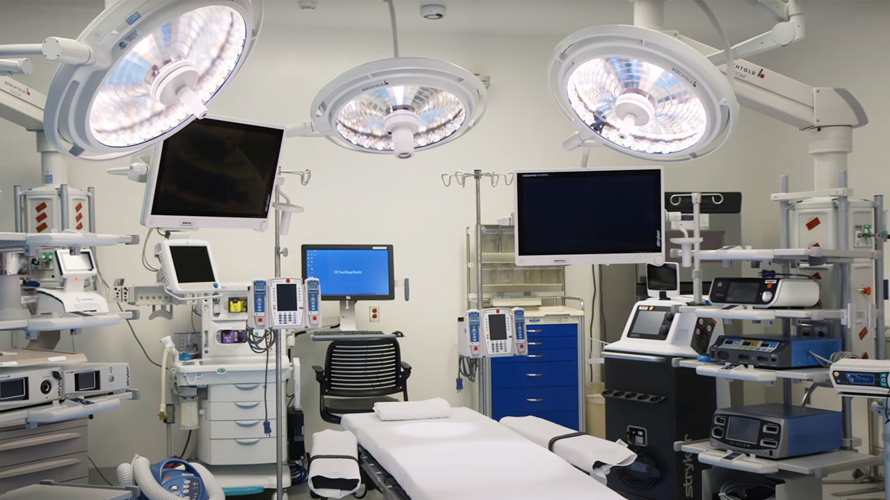 Several monitors, overhead lights and advanced equipment seen inside an operating room
